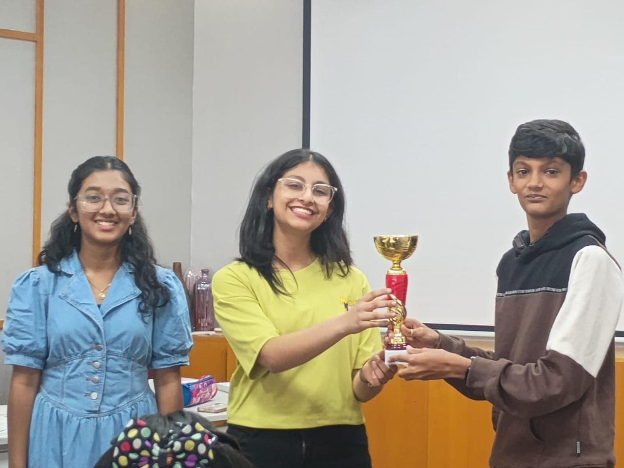 A smiling member receiving a trophy