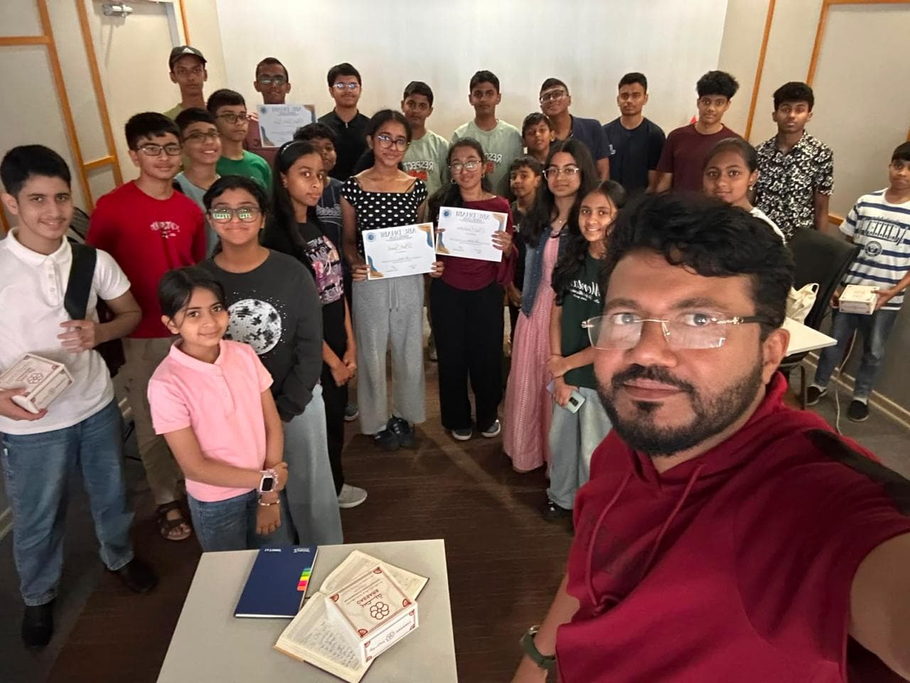 A group selfie of club members holding certificates